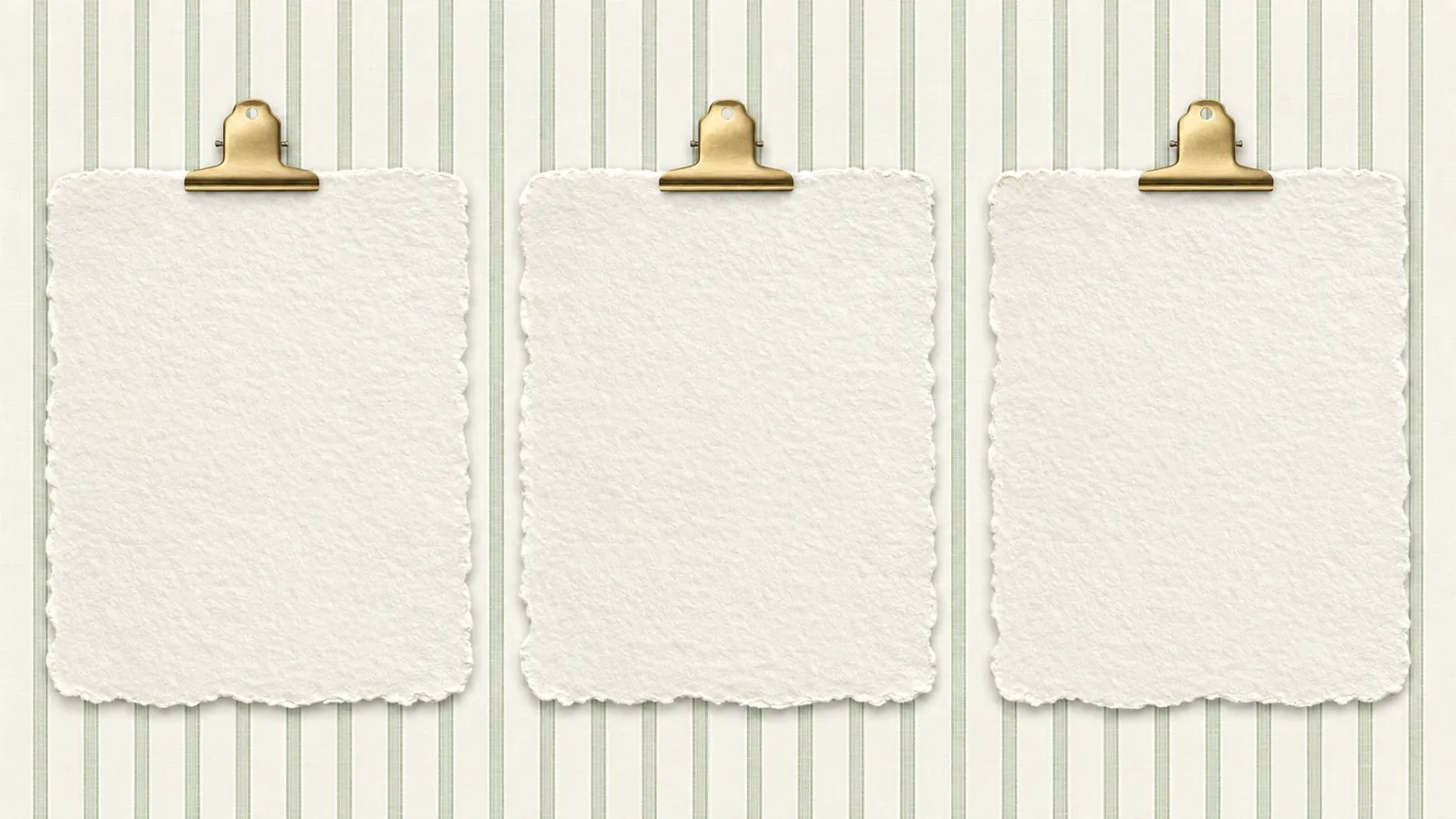 Three textured cream paper notes held by brass clips on muted green striped wallpaper