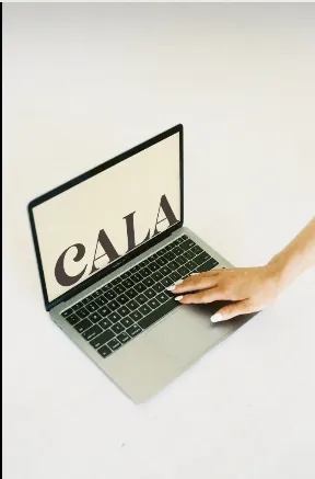 Cala Creative website displayed on a laptop with a hand on the trackpad